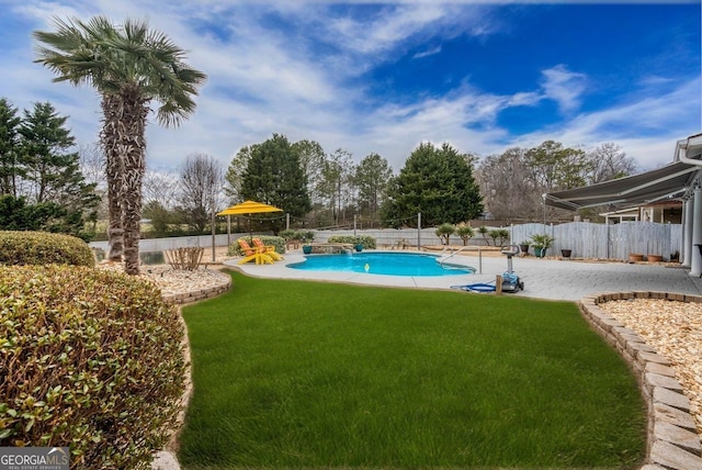 view of swimming pool with fence, a yard, a patio area, and a fenced in pool