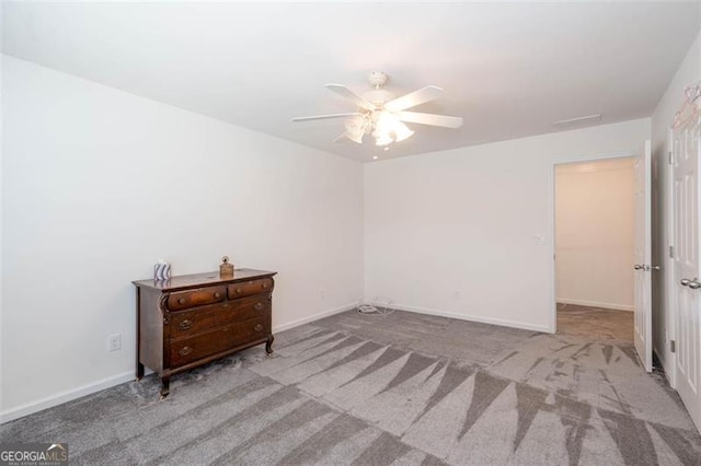 carpeted bedroom with ceiling fan and baseboards
