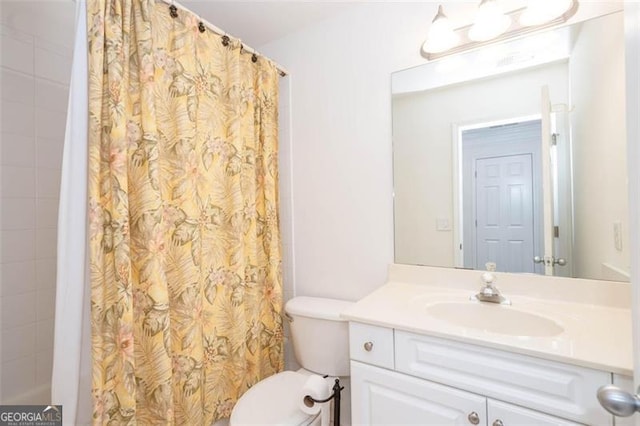 bathroom featuring toilet, a shower with curtain, and vanity
