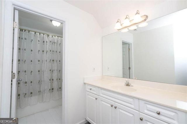 bathroom featuring shower / bath combo, tile patterned flooring, lofted ceiling, and vanity