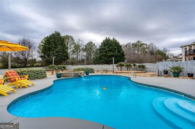 view of swimming pool with a fenced in pool, a fenced backyard, and a patio area