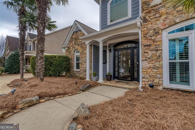 doorway to property featuring stone siding