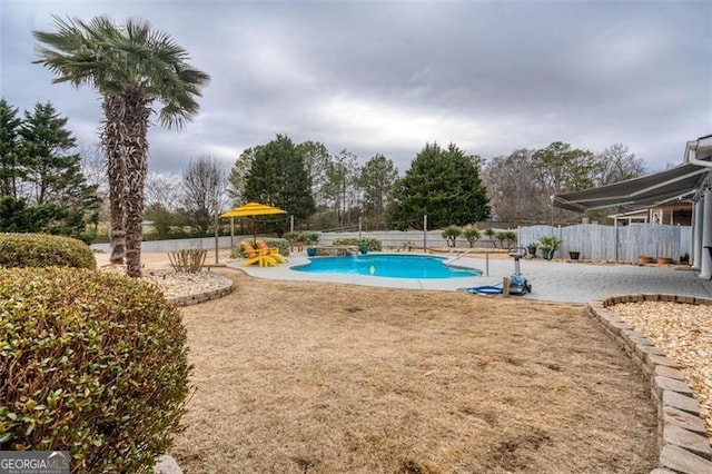 view of swimming pool featuring a fenced in pool, a patio, and fence