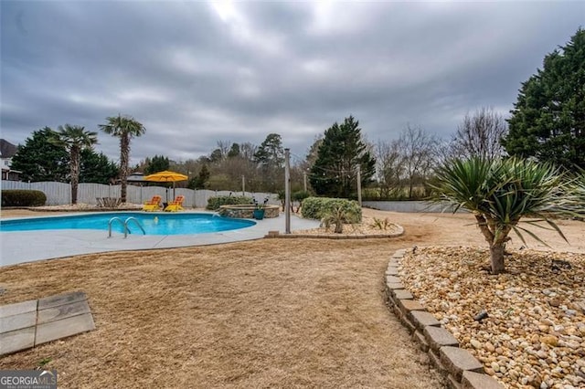 view of pool with a fenced in pool, a fenced backyard, and a patio