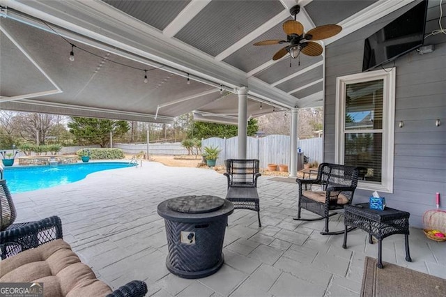 view of patio with an outdoor hangout area, fence, and a fenced in pool