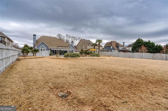 view of yard with a residential view and a fenced backyard