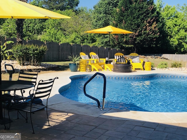 view of pool with a patio, a fenced backyard, and a fenced in pool