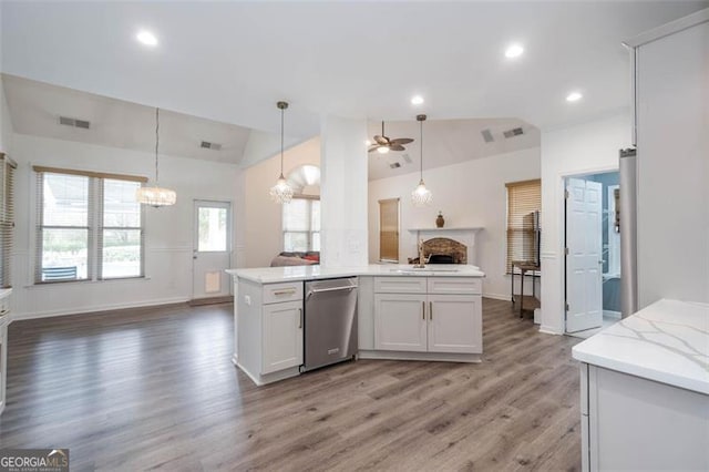 kitchen featuring dishwasher, a fireplace, light wood-type flooring, open floor plan, and lofted ceiling