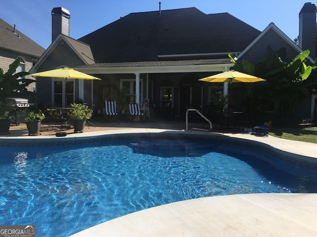 pool featuring a patio area and grilling area