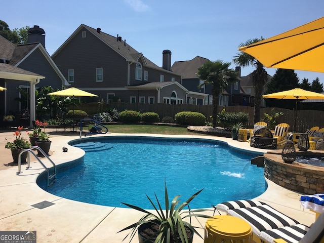 view of pool featuring a patio, an outdoor fire pit, fence, and a fenced in pool