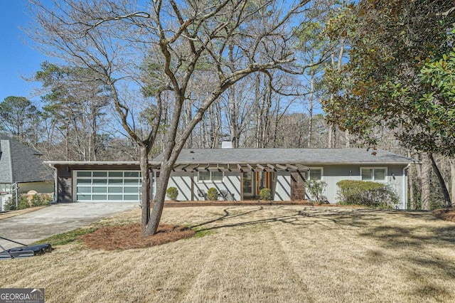 view of front of property featuring a garage, a front yard, and concrete driveway