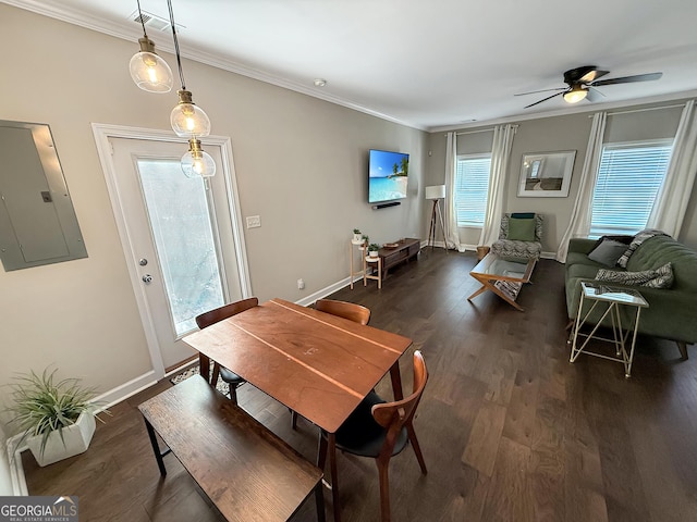 dining space featuring dark wood-style floors, electric panel, crown molding, and baseboards