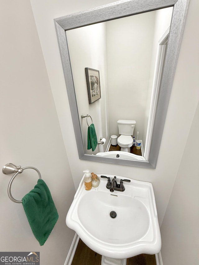 bathroom featuring toilet and a sink