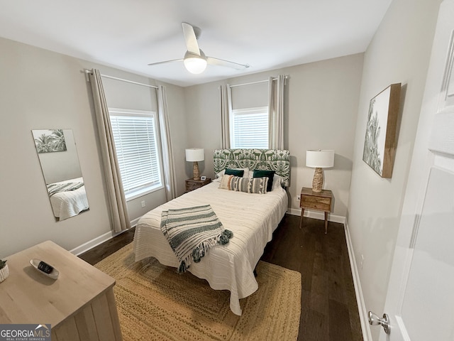 bedroom with ceiling fan, baseboards, and dark wood-style flooring