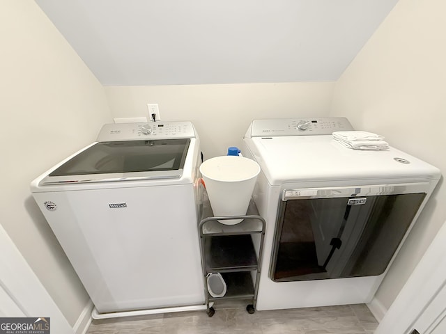 clothes washing area featuring laundry area and washer and dryer