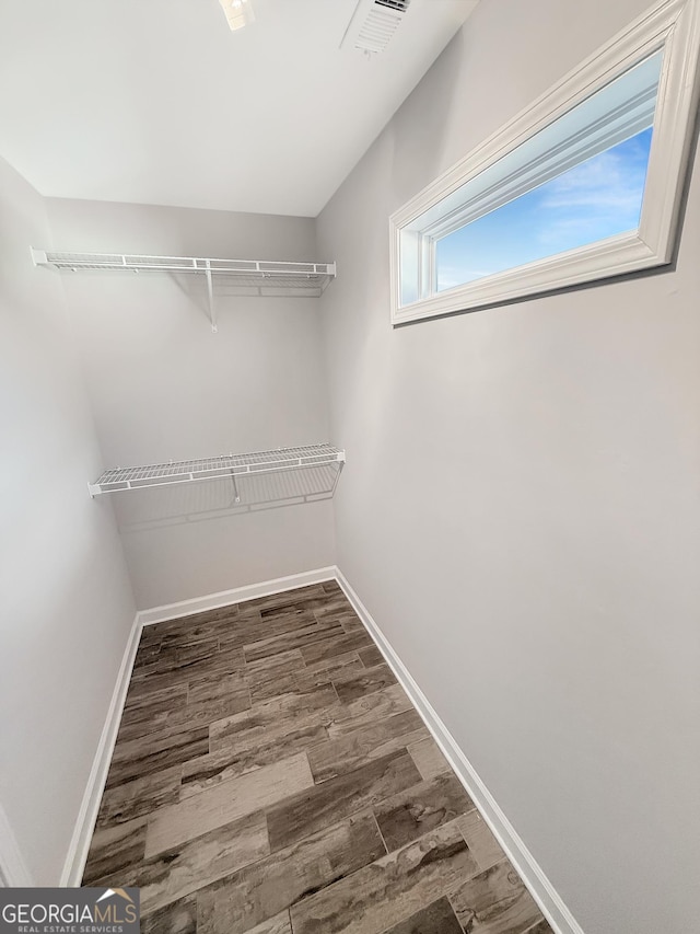 walk in closet featuring visible vents and wood finished floors