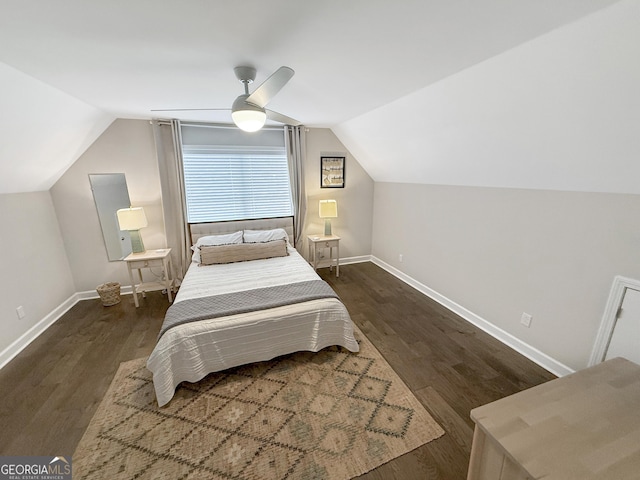 bedroom featuring vaulted ceiling, baseboards, and wood finished floors