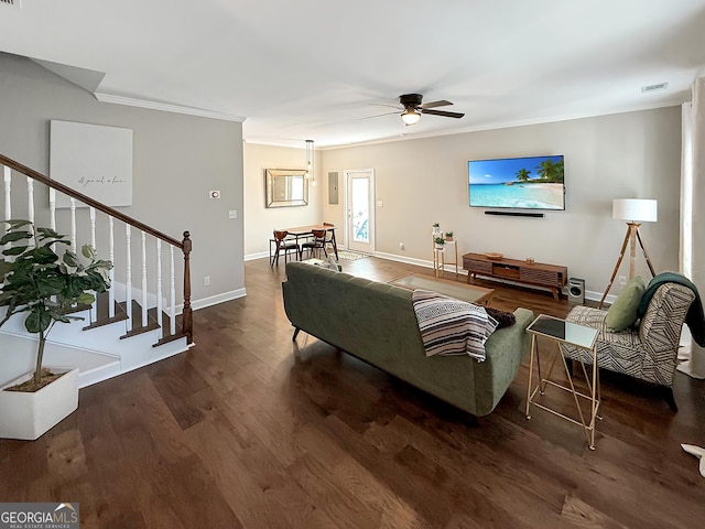 living room featuring wood finished floors, visible vents, crown molding, and stairs