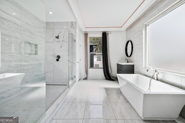 full bath with vanity, a marble finish shower, and a freestanding bath