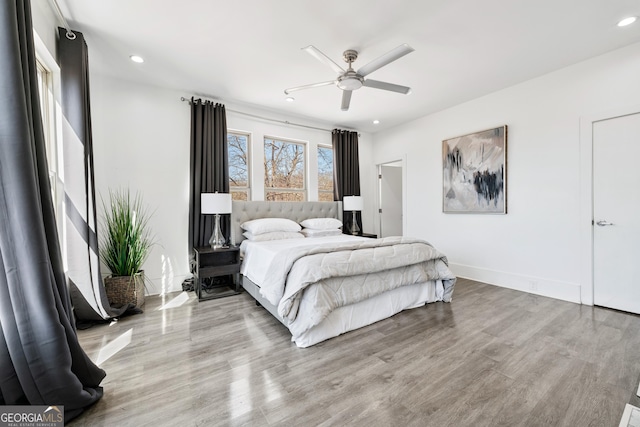 bedroom with recessed lighting, baseboards, wood finished floors, and a ceiling fan