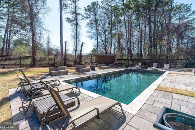 view of swimming pool featuring a fenced in pool, an outdoor hangout area, a patio, and a fenced backyard