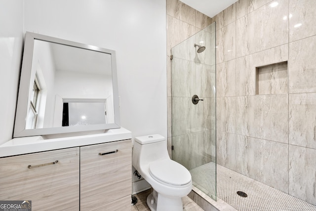 full bath featuring vanity, toilet, and tiled shower