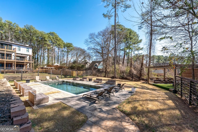 view of swimming pool with a fenced in pool, fence, and a patio area