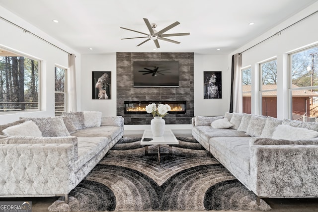 living room featuring recessed lighting, a tile fireplace, and a ceiling fan