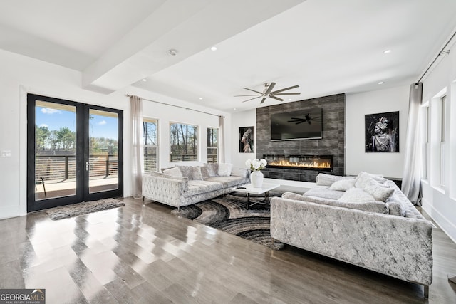 living room with recessed lighting, baseboards, wood finished floors, and a fireplace