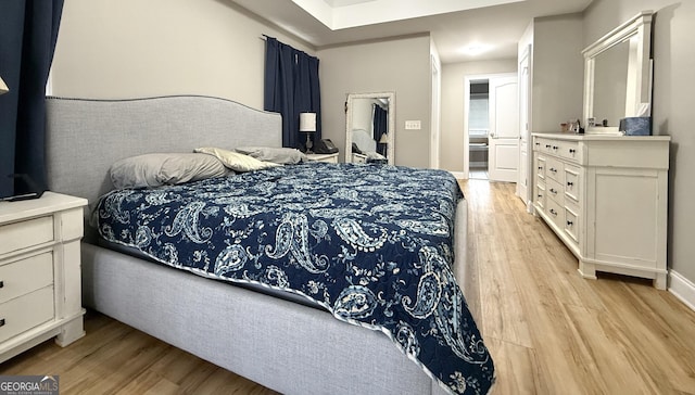 bedroom featuring light wood-style flooring and baseboards