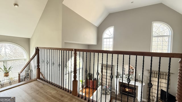 hall with vaulted ceiling and wood finished floors