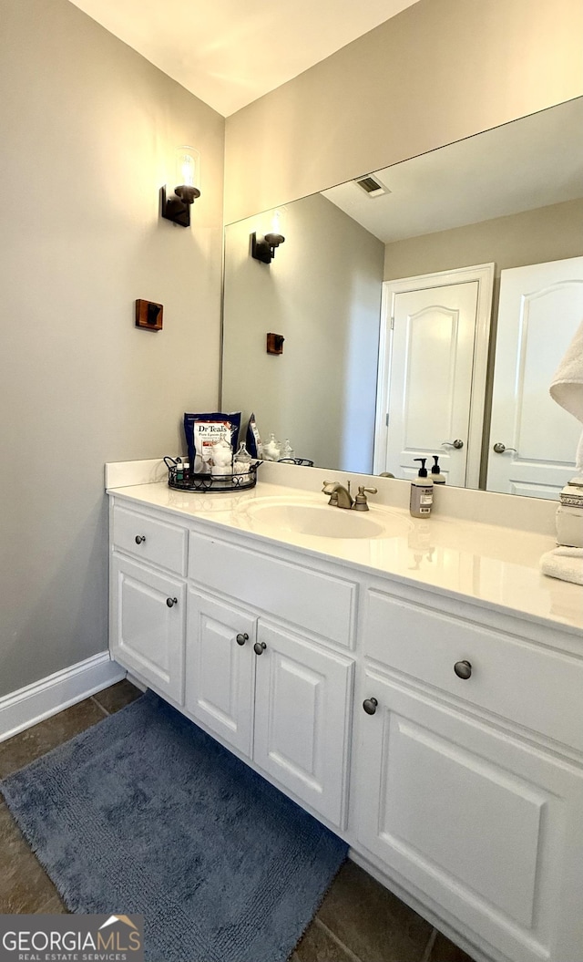 bathroom with tile patterned flooring, visible vents, vanity, and baseboards