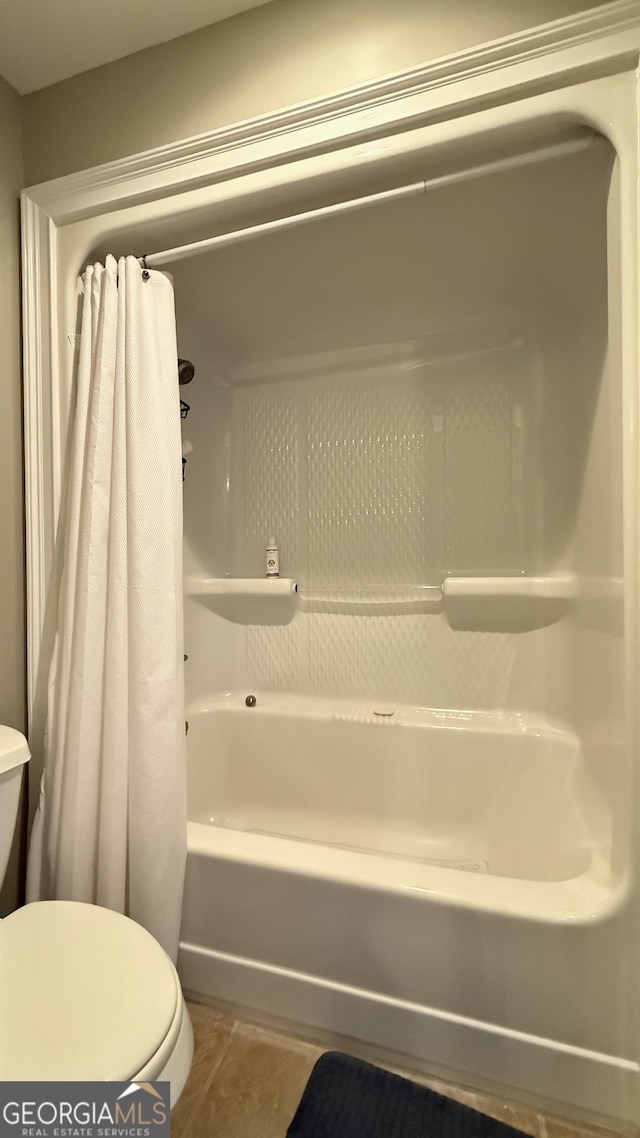 full bathroom with shower / bath combination with curtain, tile patterned flooring, and toilet