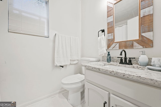 full bathroom featuring toilet, baseboards, and vanity