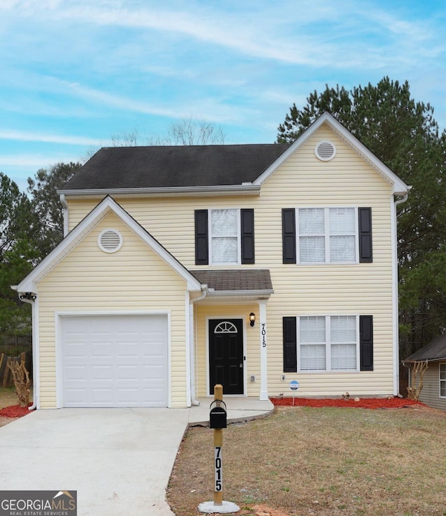 traditional-style home featuring driveway, a front lawn, roof with shingles, and an attached garage