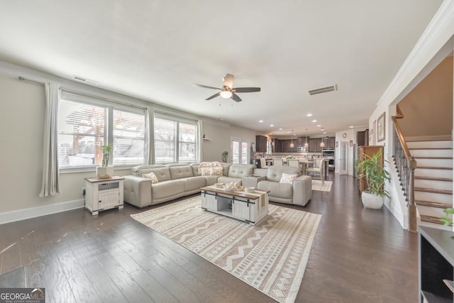 living room featuring stairway, baseboards, visible vents, and dark wood-style floors