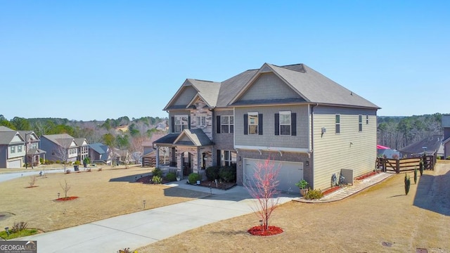 craftsman-style home featuring stone siding, driveway, and an attached garage