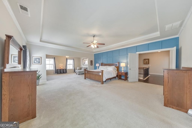 bedroom featuring visible vents, carpet flooring, crown molding, and a tray ceiling