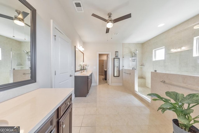 bathroom featuring visible vents, tile patterned flooring, vanity, and a walk in shower