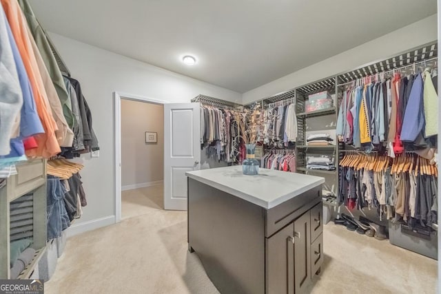 spacious closet featuring light carpet