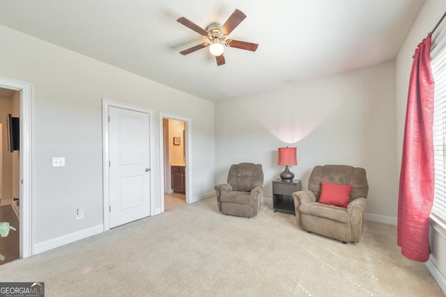 sitting room with baseboards, a ceiling fan, and carpet flooring