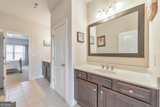 bathroom featuring vanity, baseboards, visible vents, ensuite bath, and tile patterned floors