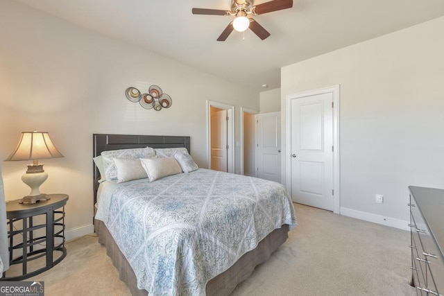 bedroom featuring light colored carpet, baseboards, and ceiling fan