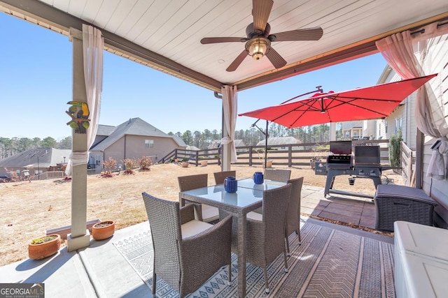 view of patio / terrace with outdoor dining space, a ceiling fan, and fence