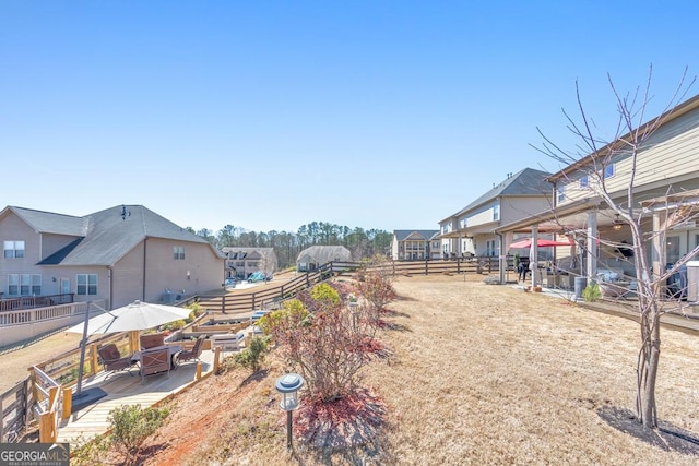 view of yard featuring a residential view and fence