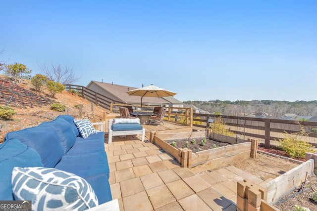 view of patio / terrace with a garden, an outdoor living space, outdoor dining space, and fence