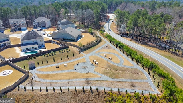 drone / aerial view featuring a view of trees