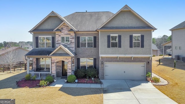 craftsman-style home featuring brick siding, a porch, concrete driveway, a garage, and stone siding