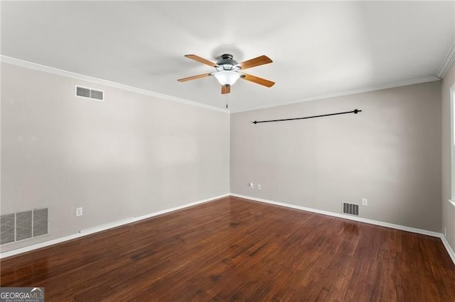 spare room featuring visible vents, crown molding, and wood finished floors