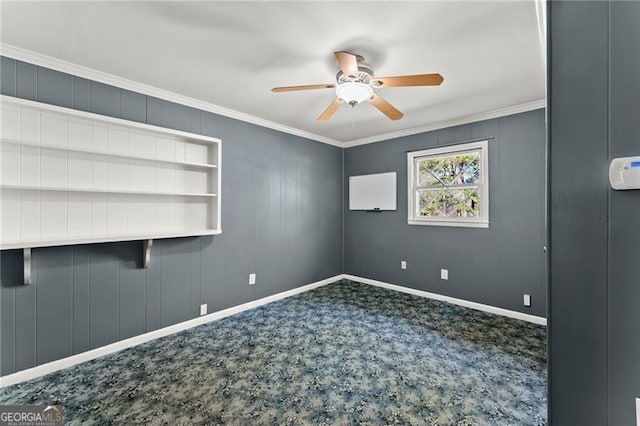 carpeted spare room featuring baseboards, a ceiling fan, and crown molding